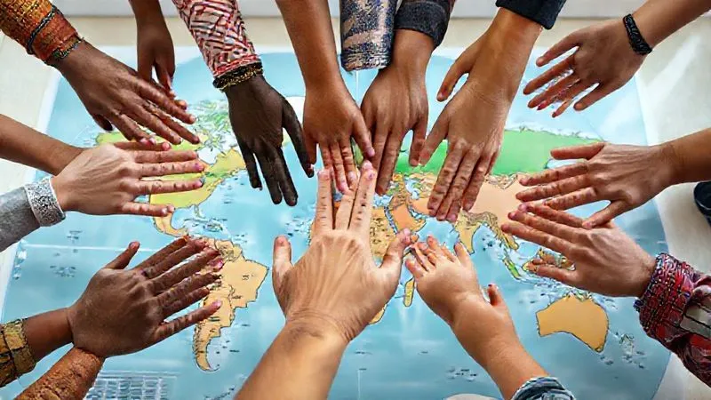 A photorealistic image of diverse hands, some with traditional patterns, others modern, reaching out to connect over a map of the world, symbolizing global connection and cultural exchange. The setting is bright and optimistic, with soft, natural lighting. Professional photography, 8K, sharp focus, depth of field.