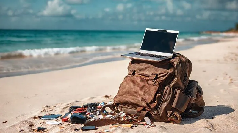 A single, weathered backpack resting on a pristine beach, with a laptop precariously balanced on top, surrounded by scattered items, conveying a sense of disorganization and overwhelm. photorealistic, professional photography, 8K, cinematic lighting, sharp focus, depth of field, shot on a high-end DSLR.