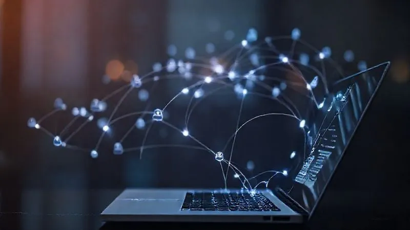 Photorealistic, professional photography of a digital footprint expanding from a forum post on a laptop screen, branching out into a complex network of connections leading to a personal website, LinkedIn profile, and other professional digital presences. The light trails are elegant and subtle, indicating growth and reach. Cinematic lighting, sharp focus on the screen and network, depth of field, 8K hyper-detailed, shot on a high-end DSLR.