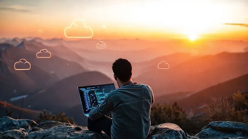 A photorealistic image of a digital nomad coding on a laptop overlooking a serene mountain landscape, with abstract glowing lines of code and cloud server icons floating around, symbolizing advanced tech skills and remote work. Cinematic lighting, sharp focus, 8K, shot on a high-end DSLR.