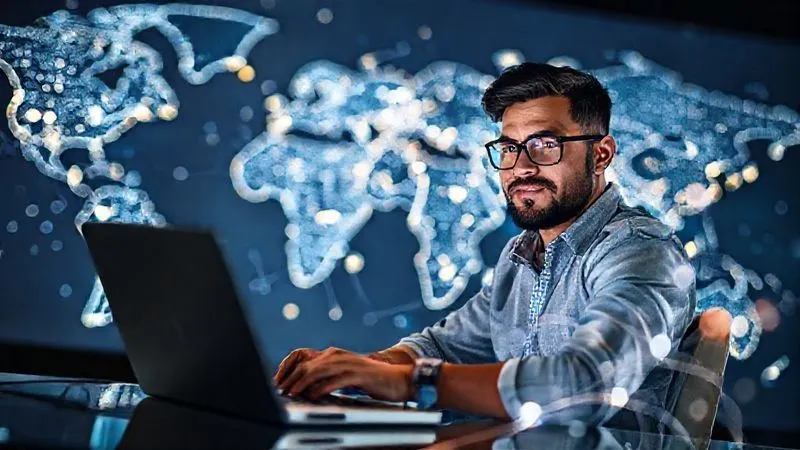 A photorealistic image of a digital nomad at a laptop, actively networking and sending emails, with a confident and determined expression. The background shows a world map with glowing connection lines, symbolizing global opportunities. Cinematic lighting, sharp focus, depth of field, 8K, high-end DSLR.